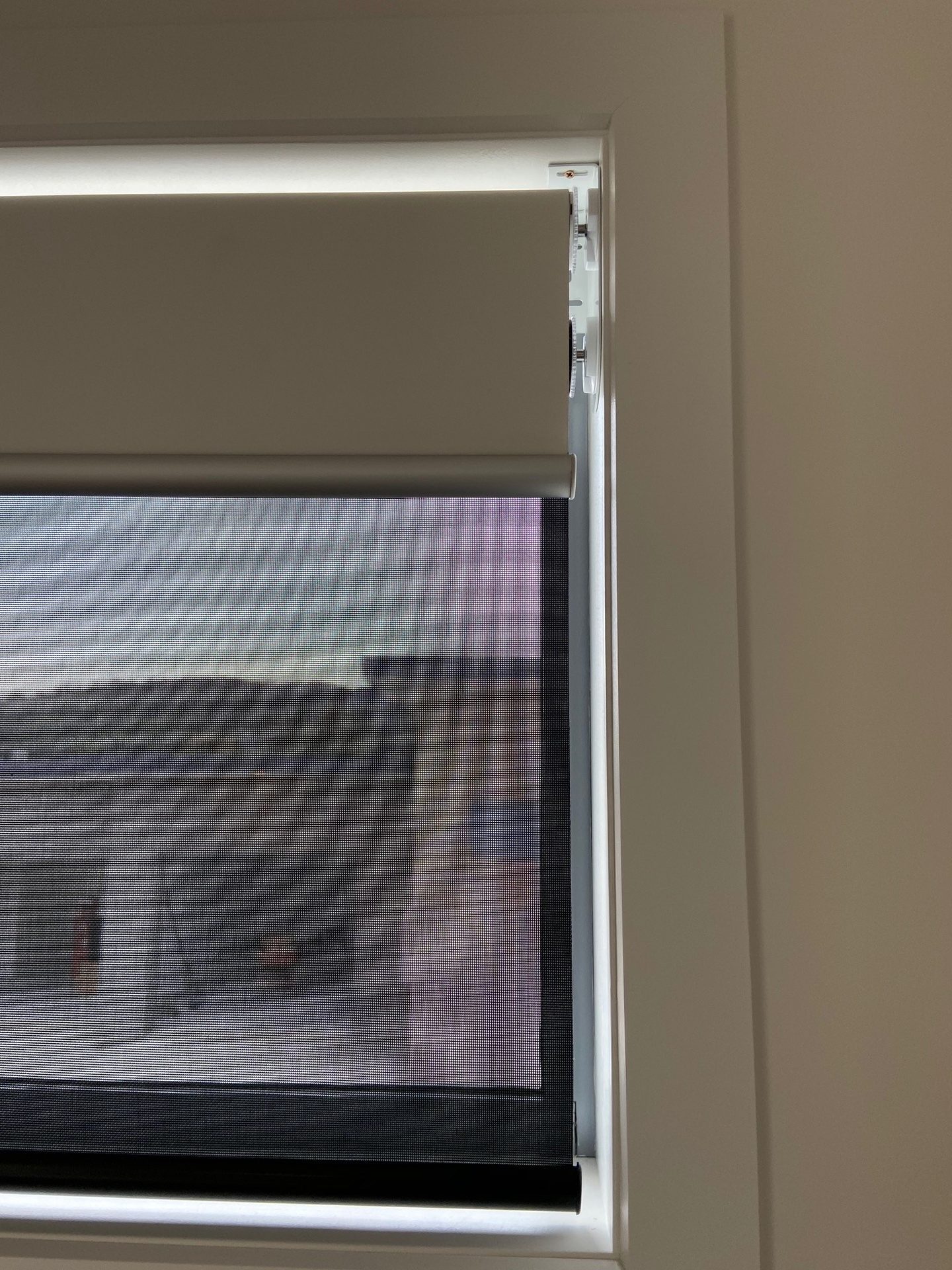 Recess fitted roller blind sitting inside the window reveal