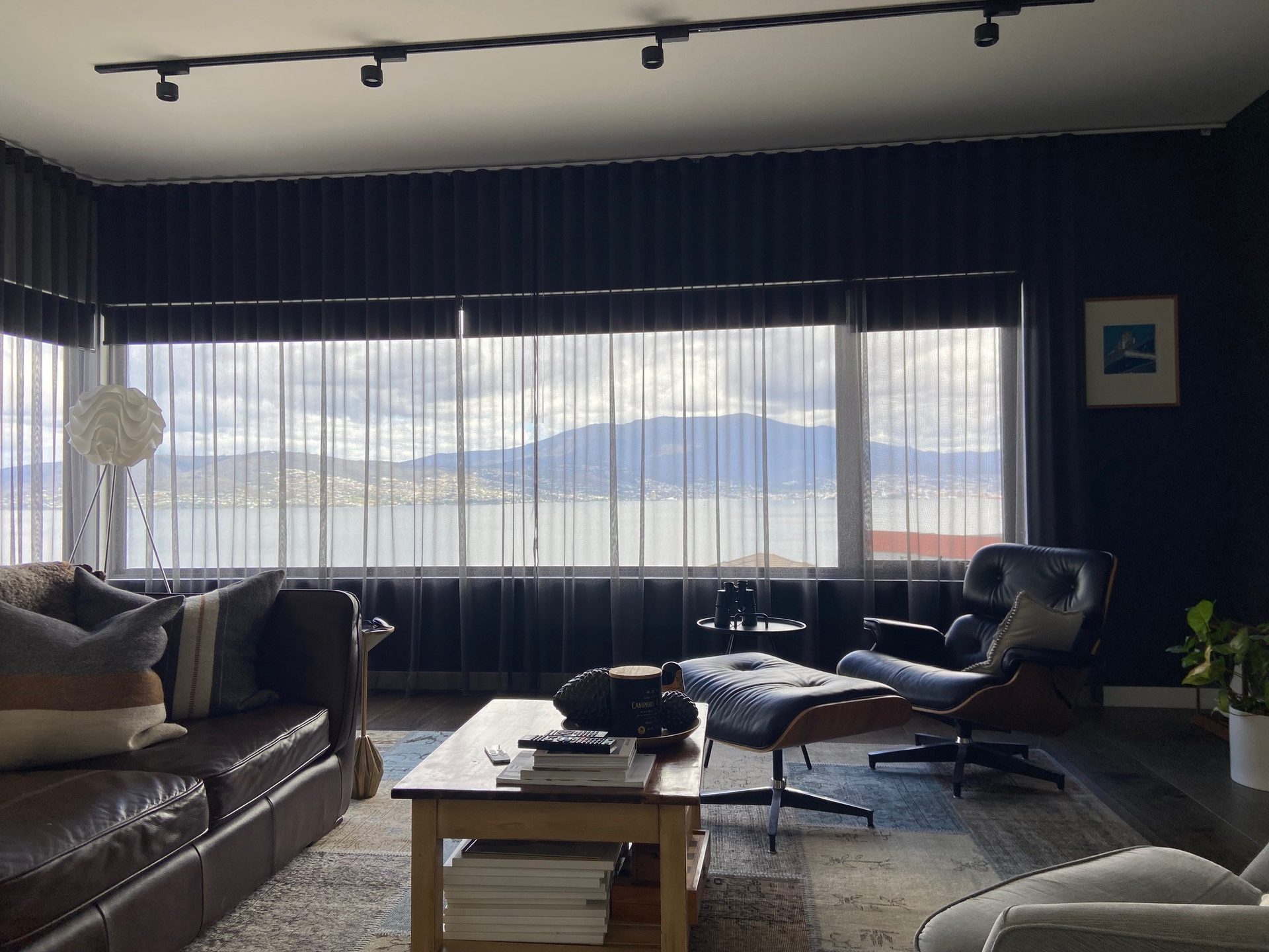 Sheer curtains paired with roller blinds in a living room