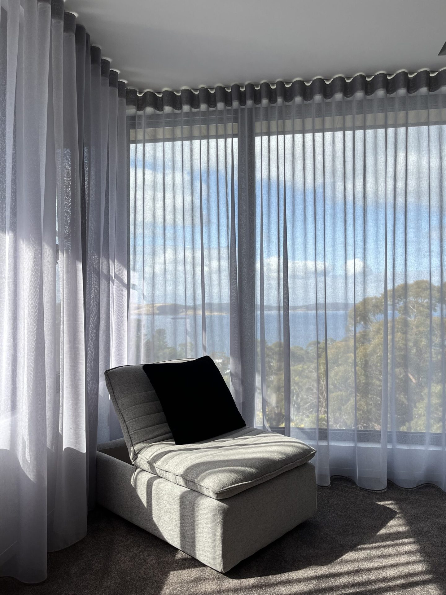 Sheer curtains across a living room window wall