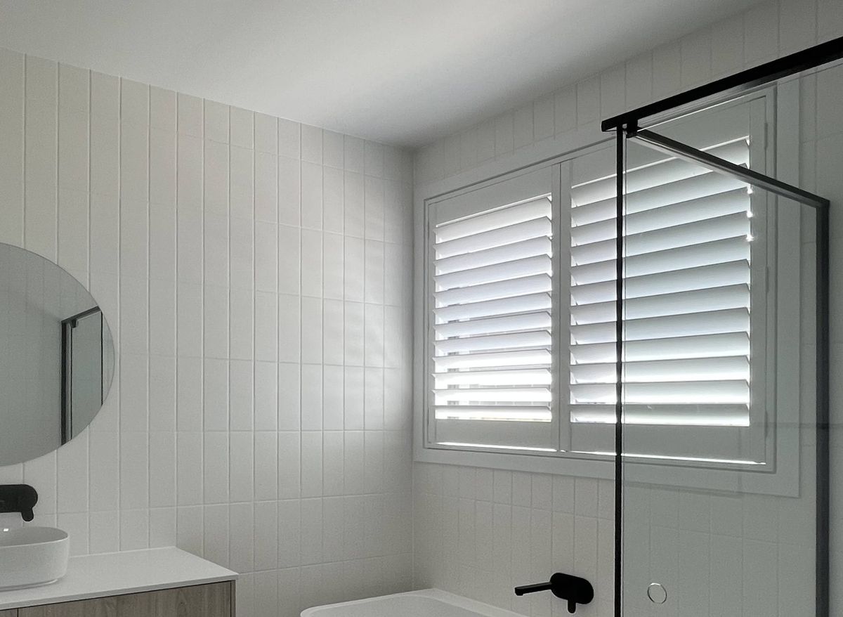 White plantation shutters fitted to a bathroom window