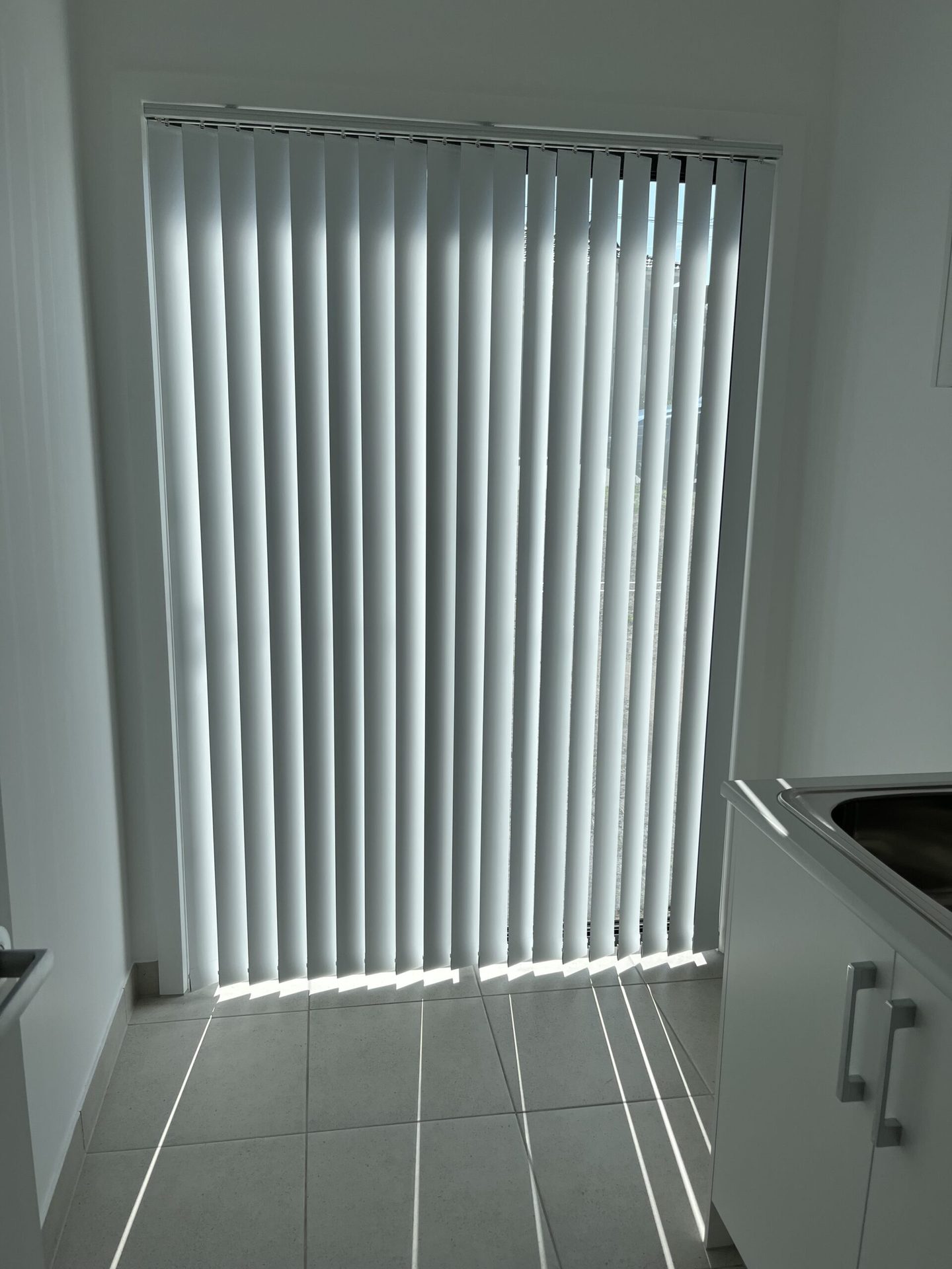 Vertical blinds across a wide living room window