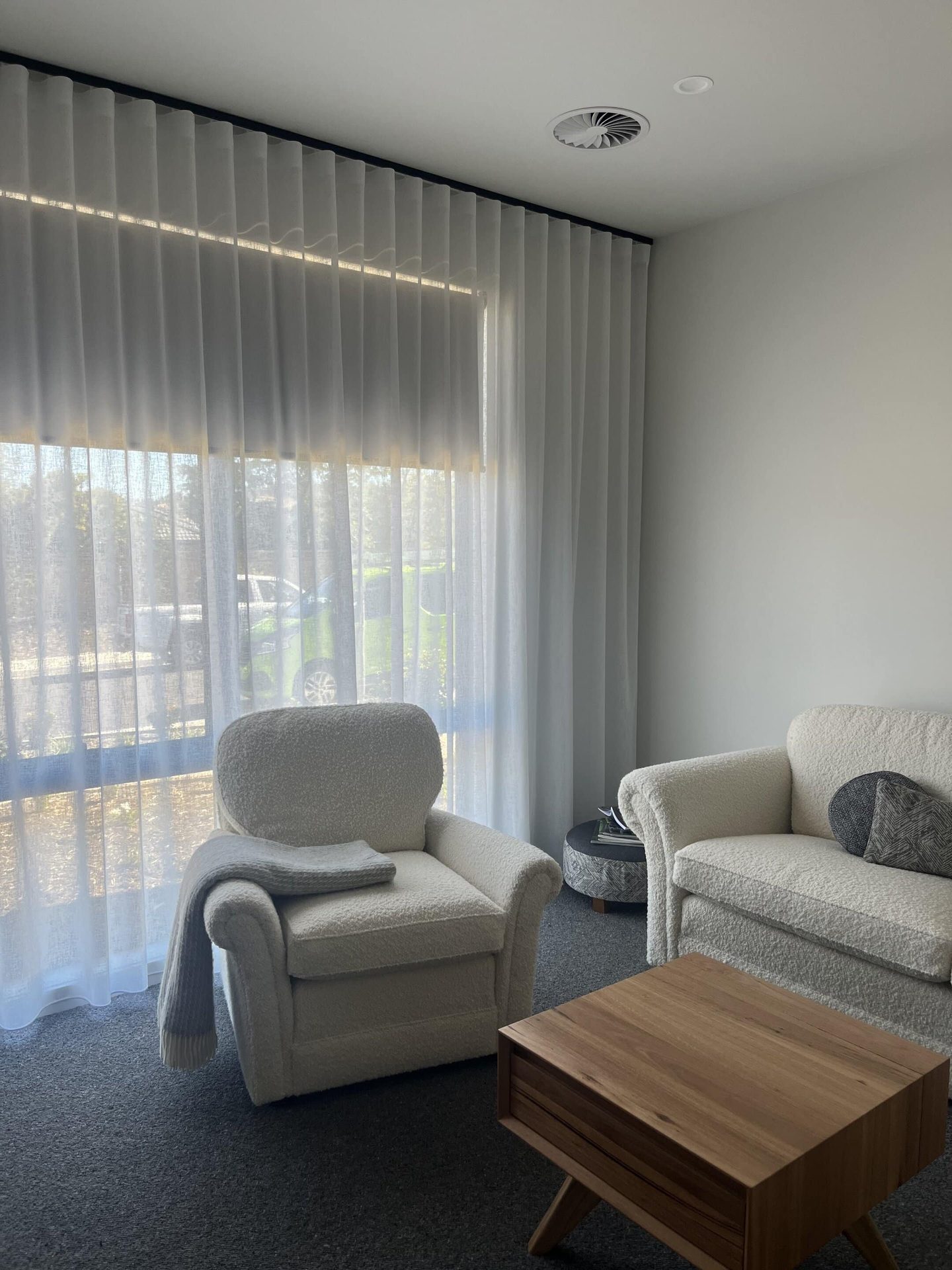 Dual roller blinds in a bathroom with tiled walls